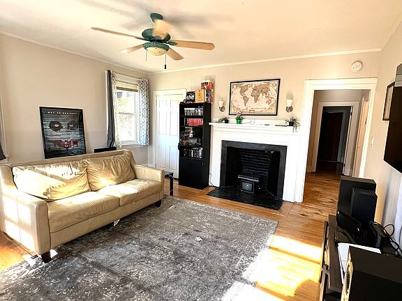 High ceilings, ceiling fan and decorative fireplace