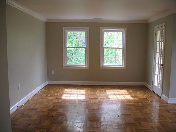 Living room with hardwood floors and windows overlooking the