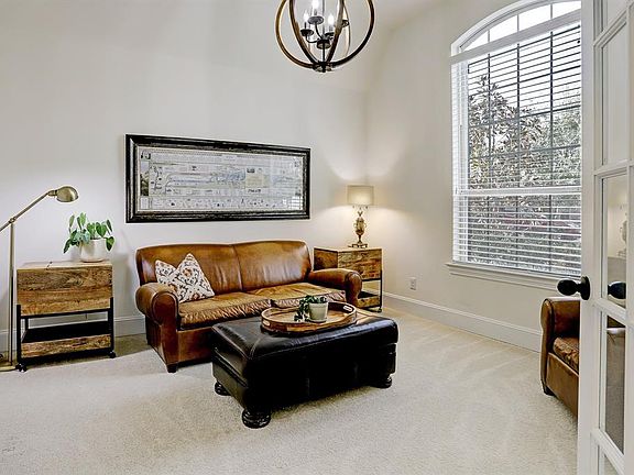 You will pass through the double French doors into the Study (currently being used as Formal Living room) to the right of the foyer entrance. This room lets in lots of natural light if you work from home.