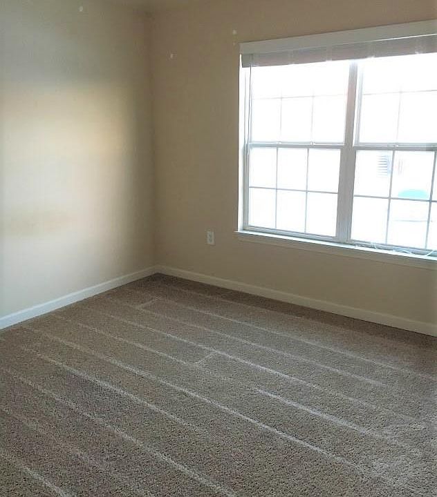 Empty bedroom with open blinds