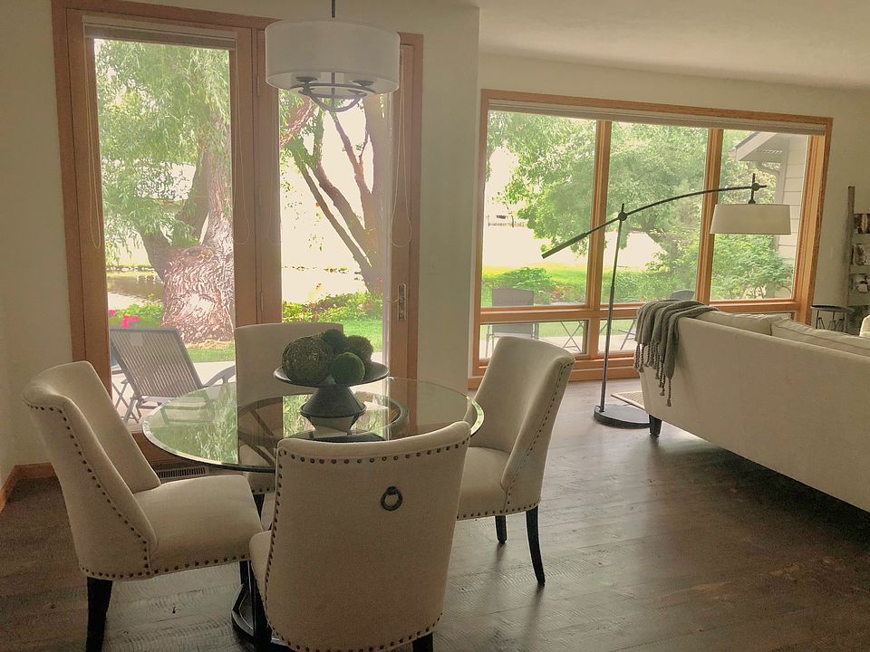 Floor to ceiling windows living/dining. Open living, dining, kitchen. Quarter sawn wood floors. View of willows, creek and pond.