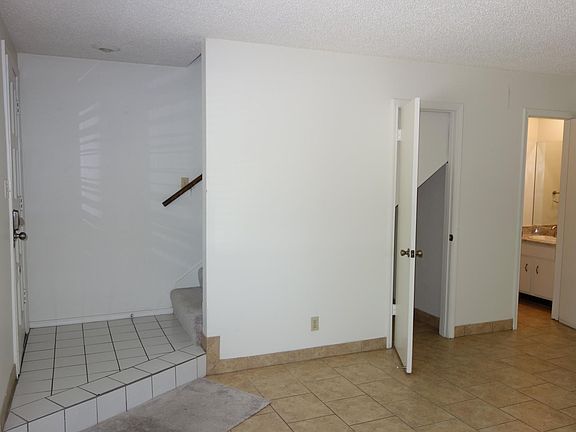 Living room view. Storage closet in center, half bath on the right.