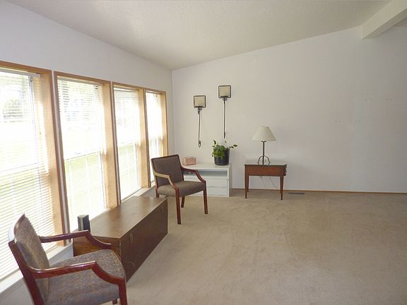 Spacious living room with lots of natural light through through the front windows.