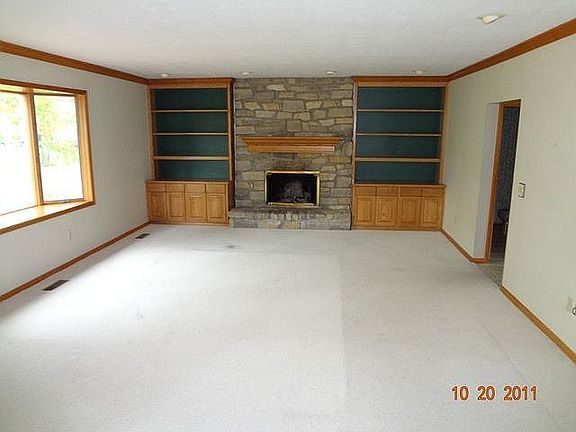 Family room with fireplace and built in book shelves.