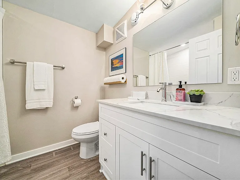 Modern main bathroom with vanity and storage in an Ottawa home.