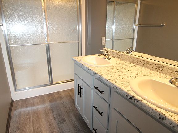 Image shows upgraded flooring and cabinets.