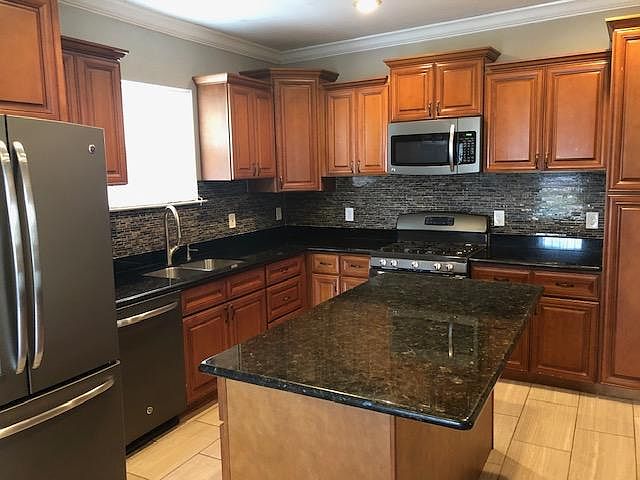 Kitchen with granite countertops and island