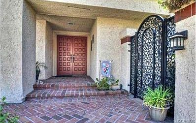 Lovely entrance and gate to front patio and around to back yard