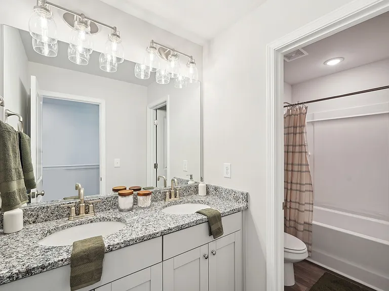 Secondary suite bathroom with a tub and shower combination