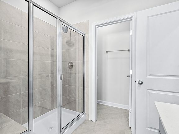 The primary ensuite boasts duel sinks, tile shower and large walk-in closet.