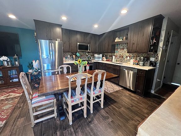 Kitchen area with upscale cabinetry and appliances.