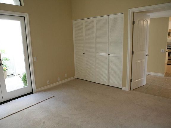 Sunlit 3rd bedroom with elegant french doors