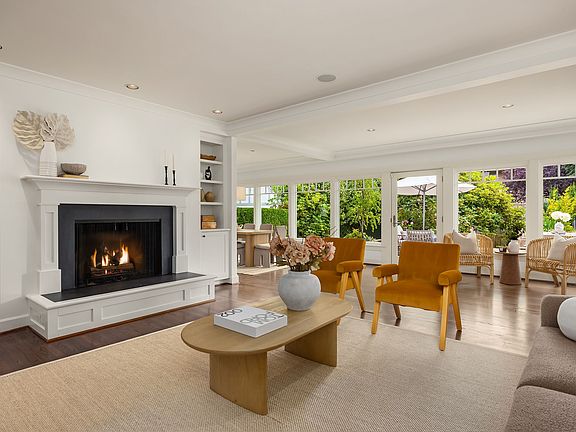 Living room and a wall of windows along the back of the home flood this home with sunshine and light.