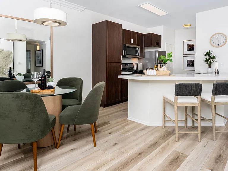 Open Kitchen with Breakfast Bar, Stainless Steel Appliances, and Dining Table