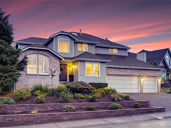 Large driveway offers plenty of off-street parking leading to 3-car garage with remote access doors via MyQ app.