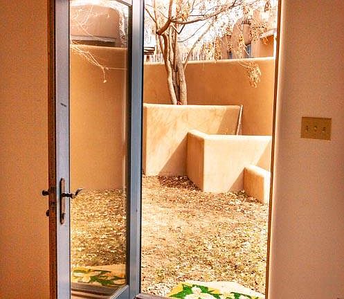 Private sunny patio off living room.