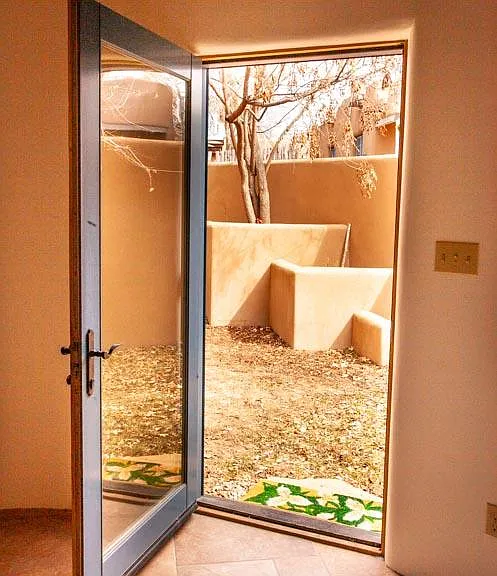 Private sunny patio off living room.