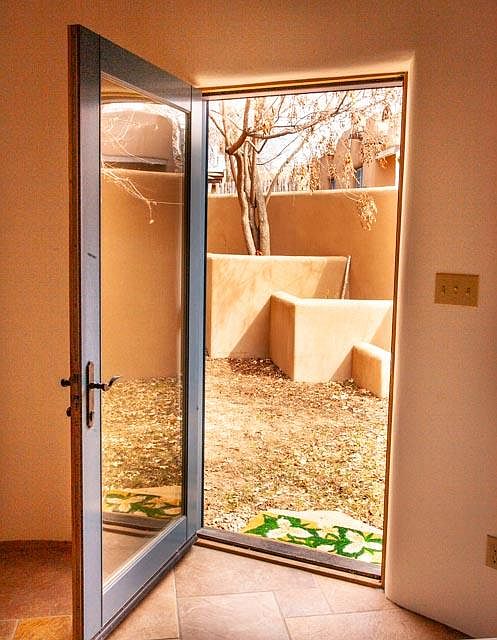 Private sunny patio off living room.