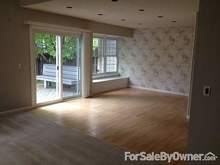 Dining Room : View from living room showing dining room, bay window, and patio door to deck