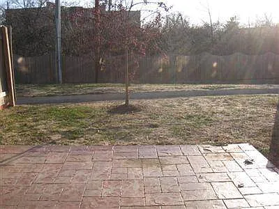 Very private backyard with concrete stamped patio.