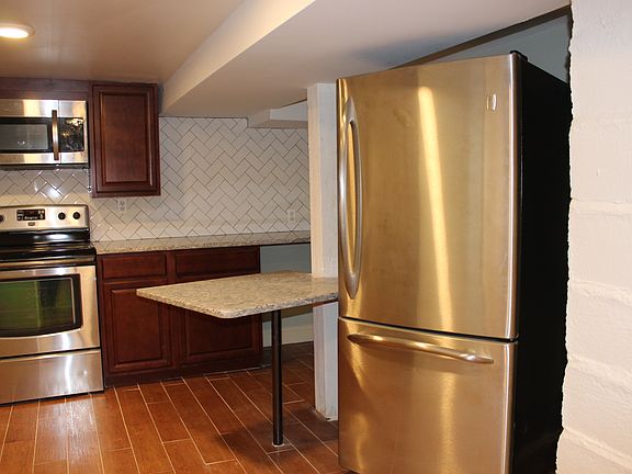 Kitchen with freezer on the bottom fridge.
