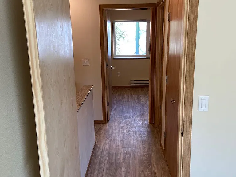 Looking from front bedroom, down hallway towards back bedroom