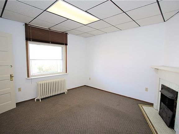 This Former Living Room Could be a 12x12 Master Bedroom for the Main Level Unit. The Large Overzised Window and the Corner Firep
