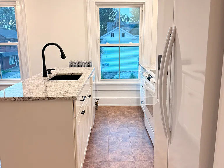 Refinished kitchen with granite, updated appliances, and fixtures.