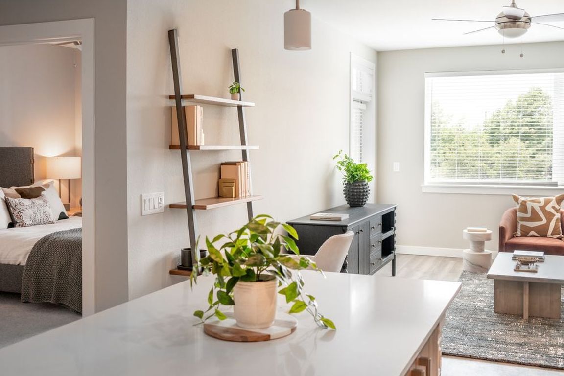 Living area with hard surface flooring and granite kitchen island
