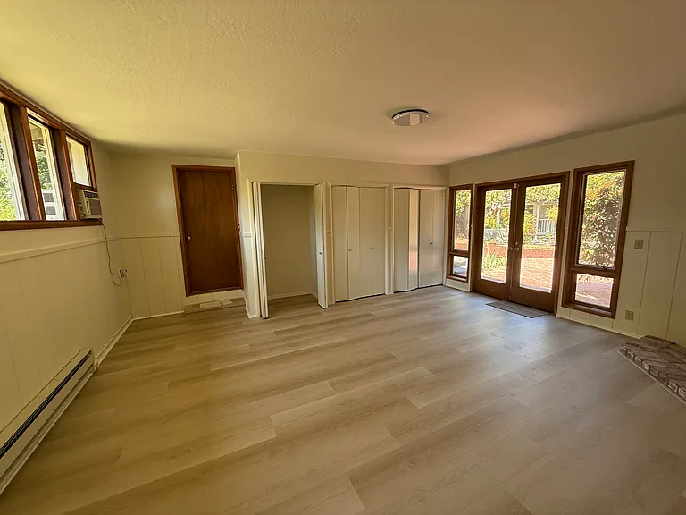 Master bedroom with French door and attached bath. New flooring.