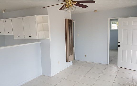 Light and bright living area and kitchen to left.