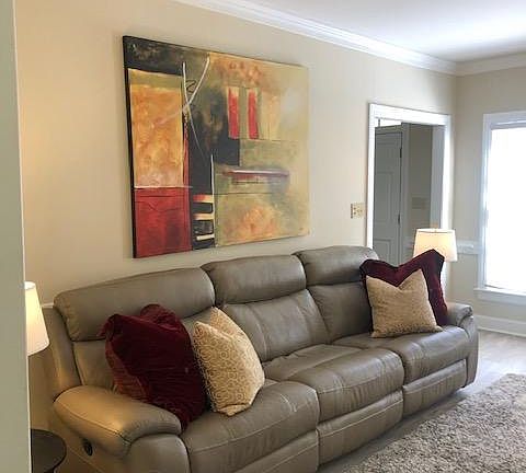 Living room with fully reclining sofa and chair.