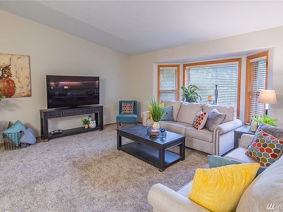 The main floor living area is open concept with vaulted ceilings. The living room is open to the kitchen and dining area.