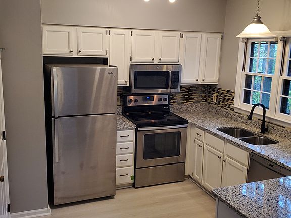 Bright Kitchen w/ Stainless steel appliances and granite countertops.