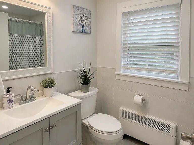 Fully renovated and immaculate bathroom with deep tub and shower.