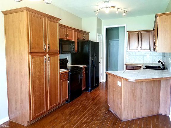 04 Kitchen with nice cabinets. Tiled counter tops. Hardwoo