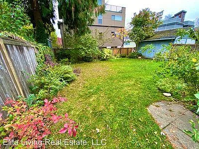 Large garden with lawn, partial shade.