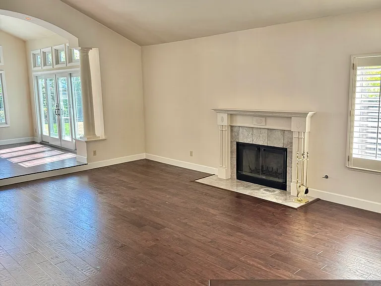 Spacious living room with fireplace, hardwood floors