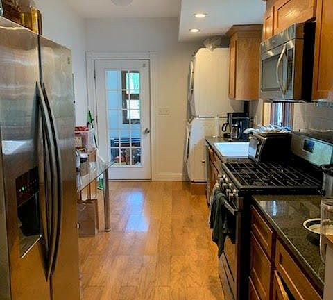 Kitchen looking at rear door to rear enclosed porch