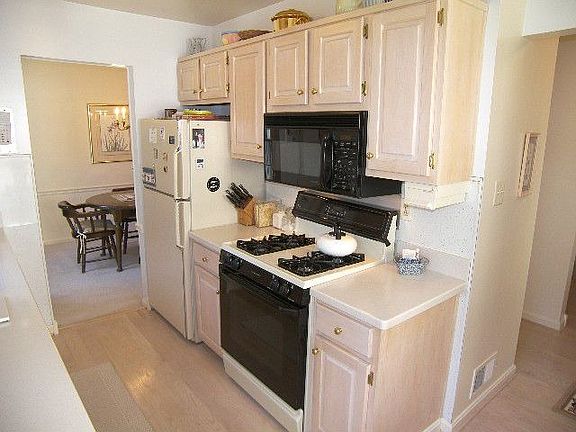 Updated Kitchen with corian counters, pretty cabinets, all new appliances.