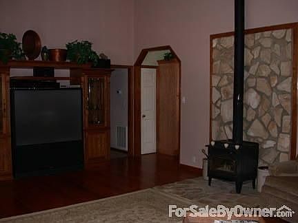 Living Room - Entertainment Area
						:
						This area shows entrance to kitchen & hallway. Shows wood burning stove.