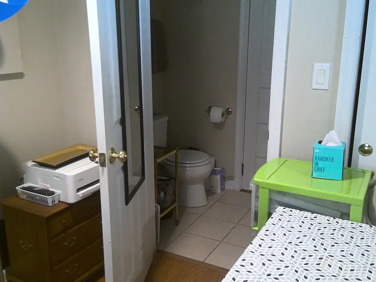 Water closet. Outer door leads to washer and dryer.