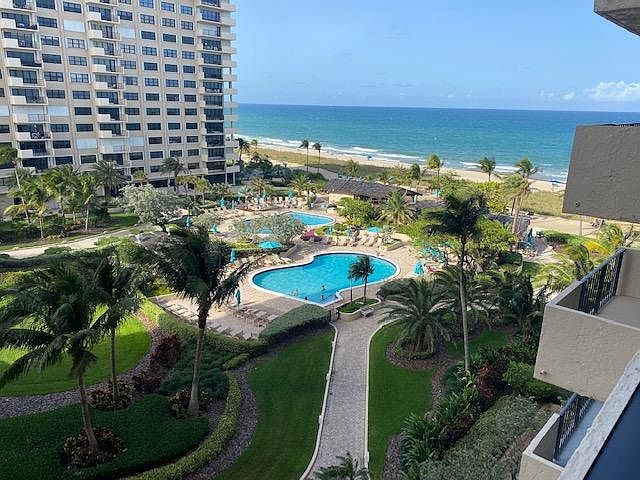View of ocean, pool, gardens, and cabanas.