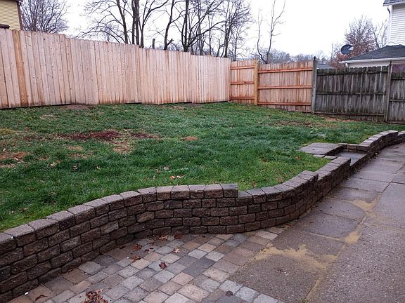 large fenced yard with patio