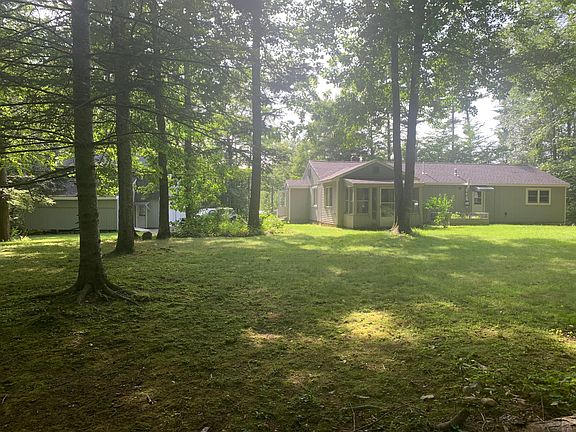 Property from backyard - garage on left, driveway, house.