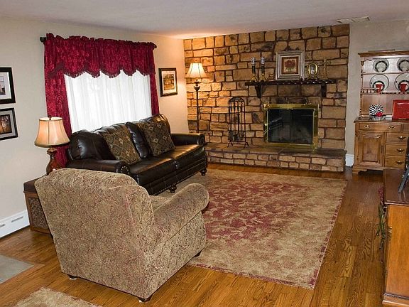Spacious Living Room with Stone Fireplace.