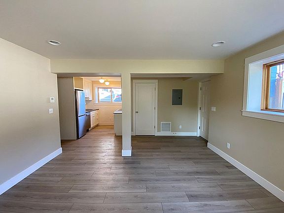 View from living/dining to kitchen. Coat closet at entry.