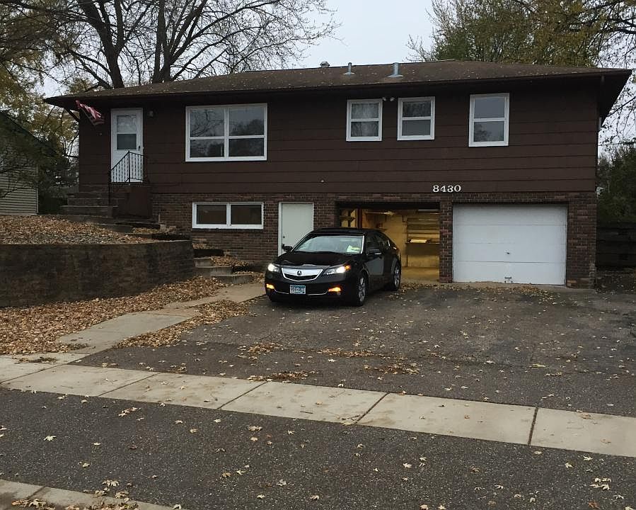 Large rambler on hill with 2 single car garages and plenty o