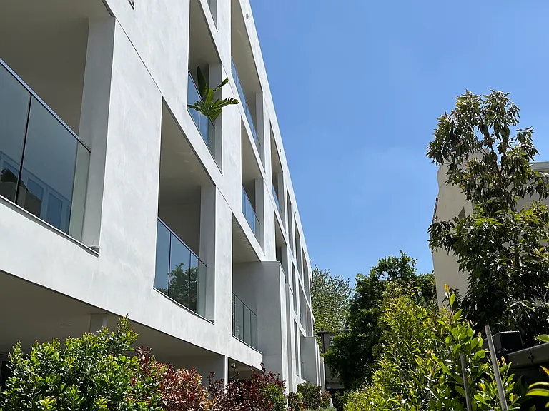 Lush Garden Pathway & South-Facing Residences _ A serene landscaped pathway leads to the residences, where bold geometric design meets natural greenery.