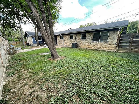 Fenced in back yard with patio and raised garden beds